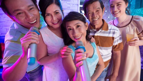 An Asian family bonding over karaoke