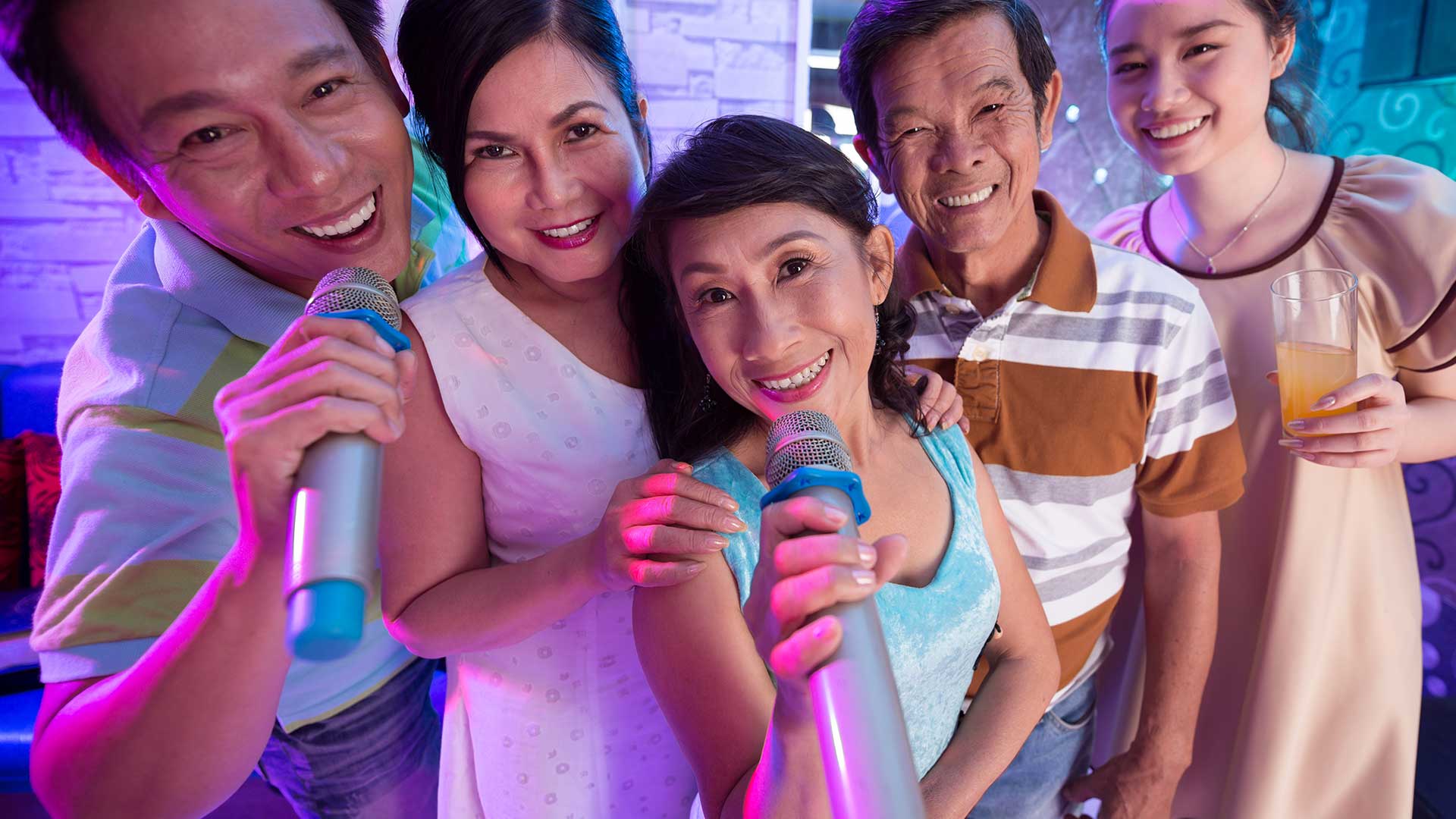 An Asian family bonding over karaoke